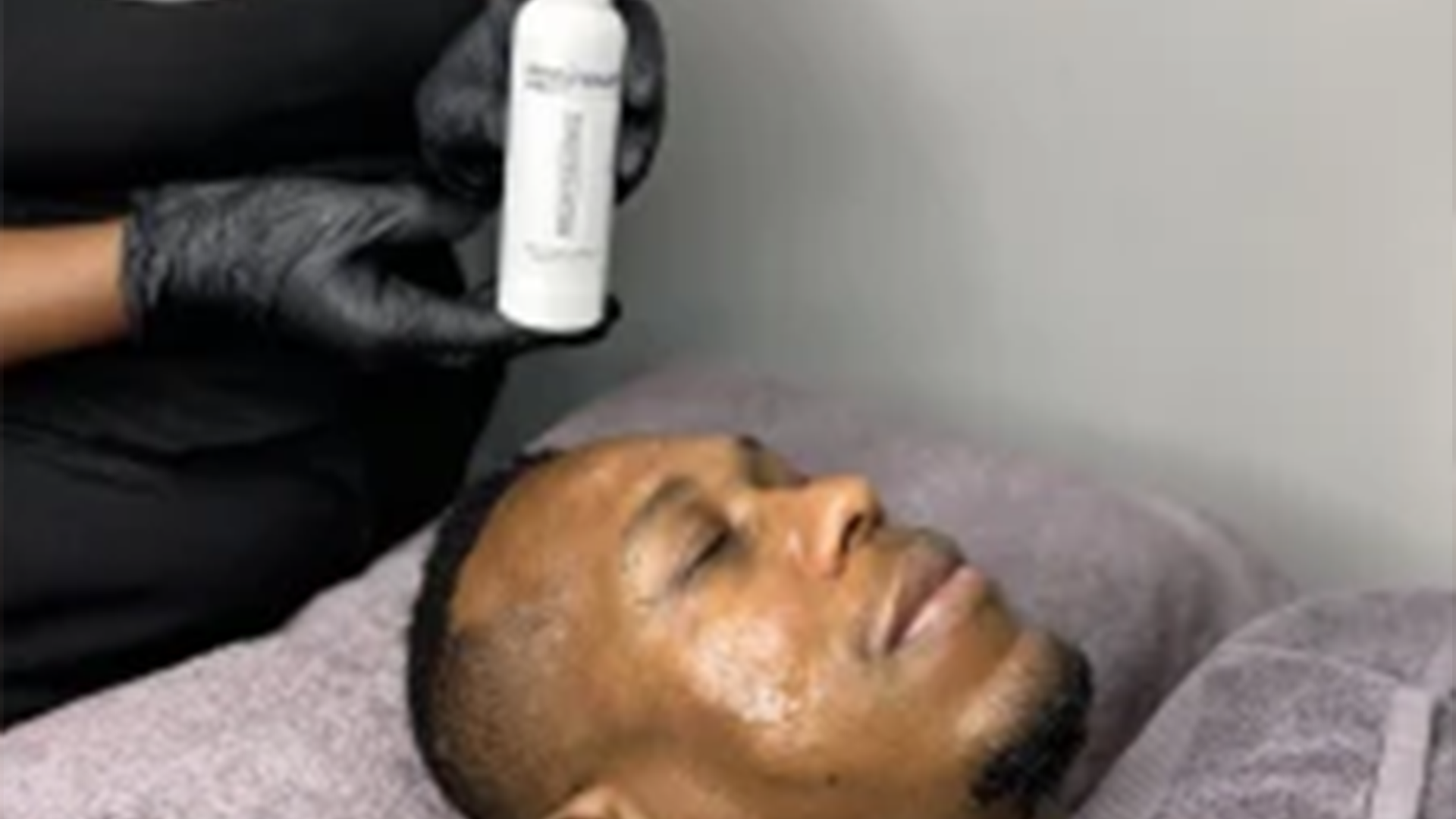 A picture of a guy getting a facial skincare treatment at monni skincare in midrand